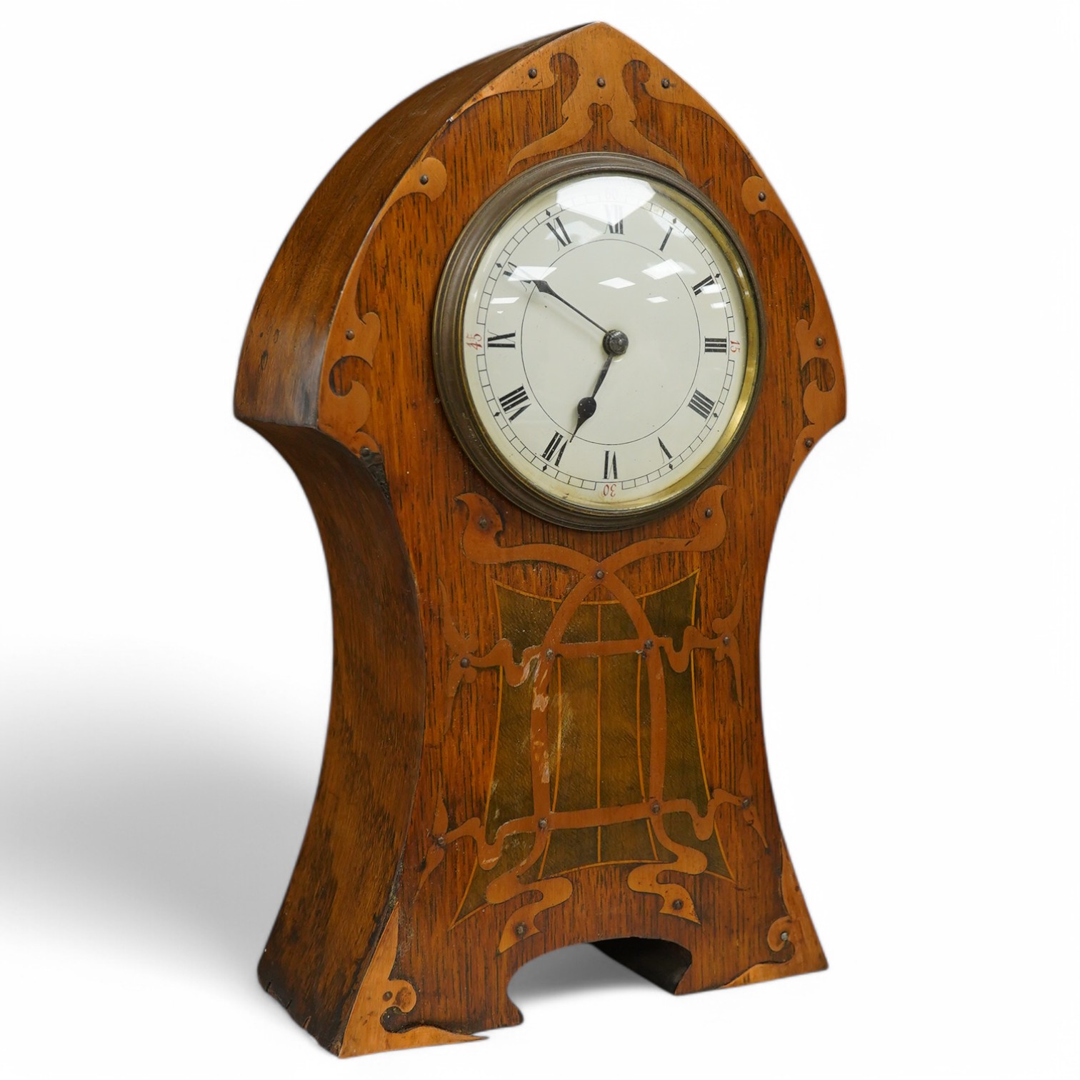 An Art Nouveau copper inlaid oak timepiece, 27cm high. Condition - various elements of copper inlay missing or detached